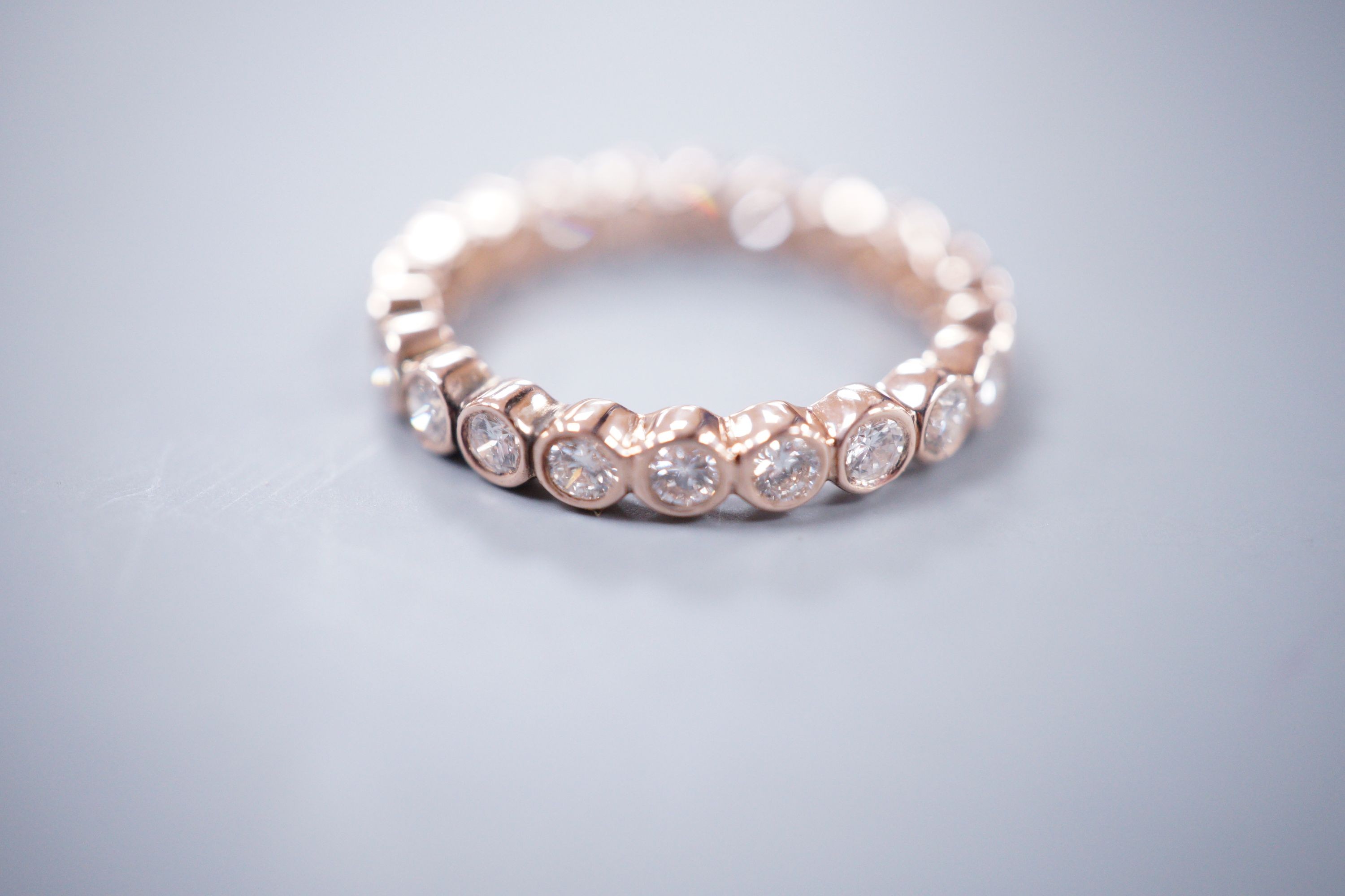 A yellow metal and diamond set full eternity ring, size N, gross weight 2.4 grams.